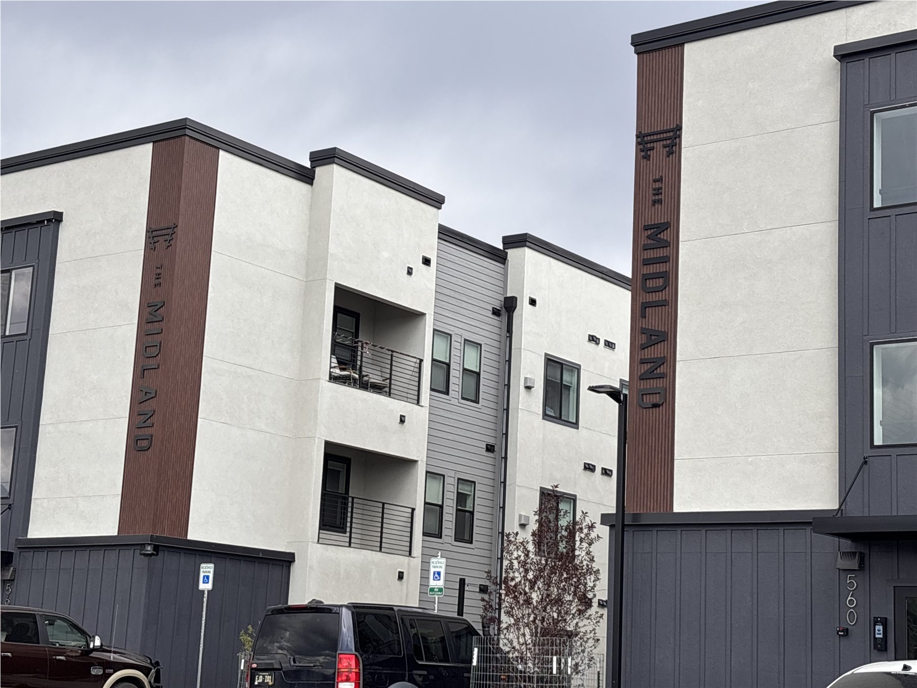 Custom vertical MIDLAND exterior metal lettering installed on an apartment building